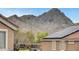 Close-up exterior view of a home featuring solar panels, set against a mountain backdrop in a Gathering-friendly neighborhood at 1552 Wild Willey Way, Henderson, NV 89002