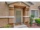 Inviting front entrance with security door, stylish stucco accents and attractive landscaping at 1552 Wild Willey Way, Henderson, NV 89002