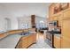 Open kitchen with stainless steel appliances, granite countertops and view of the living room at 1552 Wild Willey Way, Henderson, NV 89002