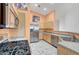 Well-lit kitchen with stainless steel appliances, tile flooring, and light-colored cabinets at 1552 Wild Willey Way, Henderson, NV 89002