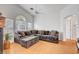 Living room with a grey sofa, fan, and natural light at 1552 Wild Willey Way, Henderson, NV 89002