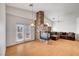Bright living room with a cozy stone fireplace, hardwood floors, and natural light from sliding doors at 1552 Wild Willey Way, Henderson, NV 89002