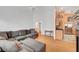 View of living room with a grey sofa and partial view of kitchen at 1552 Wild Willey Way, Henderson, NV 89002
