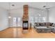 Living room with stone fireplace, vaulted ceiling, and grey sofa at 1552 Wild Willey Way, Henderson, NV 89002