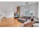 Living room with stone fireplace and grey sofa at 1552 Wild Willey Way, Henderson, NV 89002
