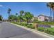 Street view featuring the 'Old Vegas' community sign, showcasing lush landscaping and palm trees under a bright blue sky at 1552 Wild Willey Way, Henderson, NV 89002