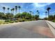 Welcoming 'Old Vegas Ranch' community sign with palm trees and vibrant greenery, offering a picturesque neighborhood view at 1552 Wild Willey Way, Henderson, NV 89002