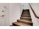 A modern staircase with sleek railings provides access to the upper level of the home at 1552 Wild Willey Way, Henderson, NV 89002