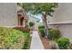 A tranquil walkway framed by lush greenery and red mulch, leading to inviting townhomes and serene outdoor living at 1552 Wild Willey Way, Henderson, NV 89002