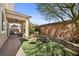 Inviting backyard featuring artificial grass, a lounge chair, and manicured landscaping perfect for outdoor relaxation and entertainment at 168 Springhouse St, Las Vegas, NV 89148