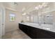 Bathroom featuring a long vanity with double sinks and a large mirror for a functional and stylish space at 168 Springhouse St, Las Vegas, NV 89148
