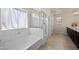 Serene bathroom showcasing a soaking tub and a separate glass-enclosed shower for a spa-like experience at 168 Springhouse St, Las Vegas, NV 89148