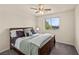 Comfortable bedroom with a queen sized bed, ceiling fan, natural light and plush carpeting at 168 Springhouse St, Las Vegas, NV 89148