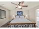 Cozy bedroom showcasing a comfortable bed, ceiling fan, and natural light, creating a serene and inviting atmosphere at 168 Springhouse St, Las Vegas, NV 89148