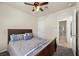 Cozy bedroom features ceiling fan, neutral walls, carpet, and bathroom access at 168 Springhouse St, Las Vegas, NV 89148