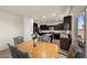 Cozy dining room with wooden table and chairs, dark cabinets and a sliding glass door to the backyard at 168 Springhouse St, Las Vegas, NV 89148