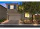 Inviting two-story home with a well-manicured front yard and a two-car garage at 168 Springhouse St, Las Vegas, NV 89148