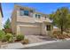 Two-story home featuring a well maintained lawn, two car garage and desert landscaping at 168 Springhouse St, Las Vegas, NV 89148