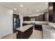 Well-appointed kitchen featuring stainless steel appliances, dark cabinetry, and a granite island at 168 Springhouse St, Las Vegas, NV 89148