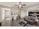 Inviting living room with wood laminate floors that leads to staircase and kitchen at 168 Springhouse St, Las Vegas, NV 89148