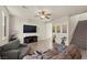 Spacious living room with hardwood floors, a ceiling fan, and a staircase at 168 Springhouse St, Las Vegas, NV 89148