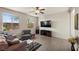 Bright living room with hardwood floors, large windows and a ceiling fan at 168 Springhouse St, Las Vegas, NV 89148