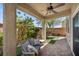 Covered patio featuring brick flooring, outdoor seating, fan, and views of the backyard landscaping at 168 Springhouse St, Las Vegas, NV 89148