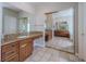 Spacious primary bathroom featuring dual vanities and a mirrored wall at 1720 Sand Storm Ct, Henderson, NV 89074