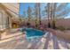 Backyard pool area with a hot tub and tropical landscaping at 1720 Sand Storm Ct, Henderson, NV 89074