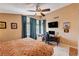 Inviting bedroom showcasing natural light from multiple windows and a dedicated desk workspace at 1721 Derbyshire Dr, Las Vegas, NV 89117