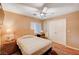 Cozy bedroom with neutral tones, wood floors, and a ceiling fan, providing a peaceful and inviting atmosphere for relaxation at 1721 Derbyshire Dr, Las Vegas, NV 89117