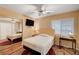 Comfortable bedroom featuring a neutral palette, ceiling fan, and ample natural light, designed for relaxation and tranquility at 1721 Derbyshire Dr, Las Vegas, NV 89117
