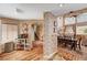 Open-concept dining room featuring wood floors, brick accents, and natural light at 1721 Derbyshire Dr, Las Vegas, NV 89117