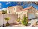 Two-story home with well-kept landscaping, gated entrance, and attached garage at 1721 Derbyshire Dr, Las Vegas, NV 89117