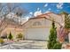 Charming single-Gathering home with a tile roof, two-car garage, and well-maintained landscaping at 1721 Derbyshire Dr, Las Vegas, NV 89117