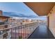 Spacious balcony offering panoramic views of the city skyline with black tile floors and metal railings at 205 E Harmon Ave # 1010, Las Vegas, NV 89169