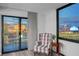 Relaxing balcony view overlooking the cityscape, complete with a comfortable chair and side table at 205 E Harmon Ave # 1010, Las Vegas, NV 89169