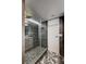 Modern bathroom features a glass shower, gray tiled walls, and distinctive stone accents at 205 E Harmon Ave # 1010, Las Vegas, NV 89169