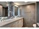 Elegant bathroom with a double sink vanity, marble accents, and modern fixtures at 205 E Harmon Ave # 1010, Las Vegas, NV 89169