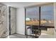 This bedroom features accent wall, desk, wood-look flooring and great city views at 205 E Harmon Ave # 1010, Las Vegas, NV 89169