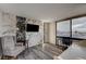 Bedroom featuring accent wall, wood-look flooring, and a window with a beautiful city view at 205 E Harmon Ave # 1010, Las Vegas, NV 89169