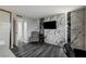 Bedroom features accent wall with wood-look flooring and a nearby closet with sliding mirrored doors at 205 E Harmon Ave # 1010, Las Vegas, NV 89169