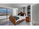Bedroom features wood-look flooring, accent wall, a big window and a wooden bed frame at 205 E Harmon Ave # 1010, Las Vegas, NV 89169