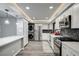 Spacious kitchen featuring sleek appliances, white cabinets, stylish backsplash, and hardwood floors at 205 E Harmon Ave # 1010, Las Vegas, NV 89169