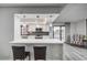 Modern kitchen with stainless steel appliances, white cabinets, quartz counters, and breakfast bar seating at 205 E Harmon Ave # 1010, Las Vegas, NV 89169