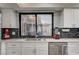 Kitchen close-up featuring modern sink, stainless appliances, updated backsplash, and lots of natural light at 205 E Harmon Ave # 1010, Las Vegas, NV 89169