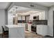Spacious kitchen features stainless appliances, white cabinets, quartz counters, and an island with seating at 205 E Harmon Ave # 1010, Las Vegas, NV 89169
