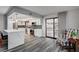 Bright kitchen features stainless appliances, white cabinets, quartz counters, and luxury vinyl plank flooring at 205 E Harmon Ave # 1010, Las Vegas, NV 89169