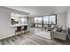 Inviting living room with modern gray sofa, wood floors, and beautiful city views at 205 E Harmon Ave # 1010, Las Vegas, NV 89169