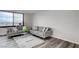 Comfortable living room showcasing stylish gray sofas, wood floors, and a bright window at 205 E Harmon Ave # 1010, Las Vegas, NV 89169